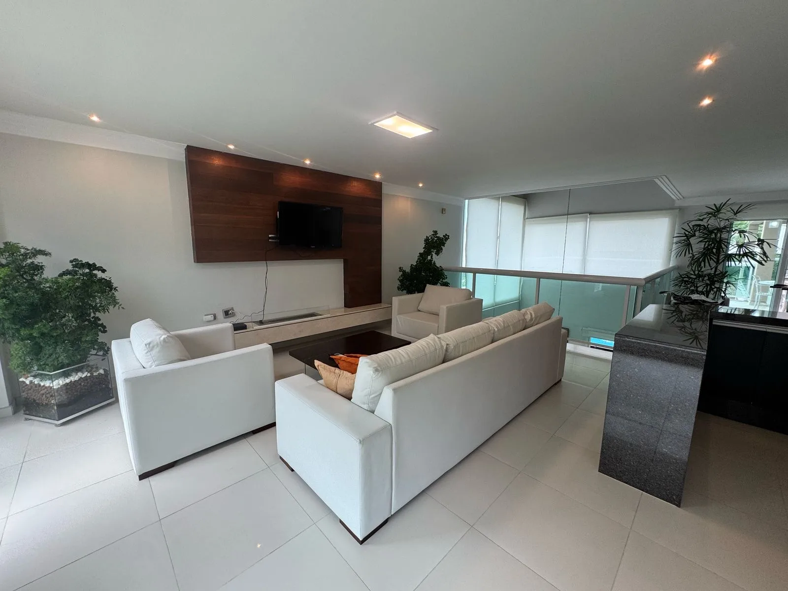 Sala de estar com varanda de vidro